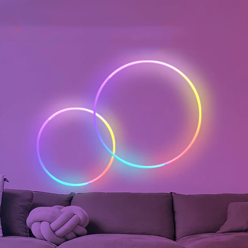 Two circles creative shapes neon lights on the sofa wall.