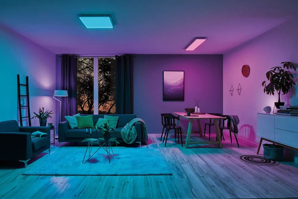 A living room with gradient mood lighting from purple to blue.