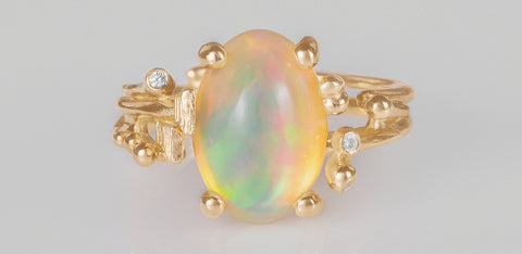 opal dress ring set in yellow gold with diamonds in bohemian style