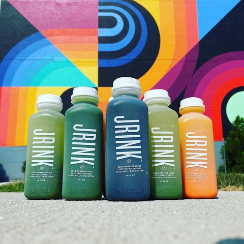 5 cold pressed juices lined up in a row