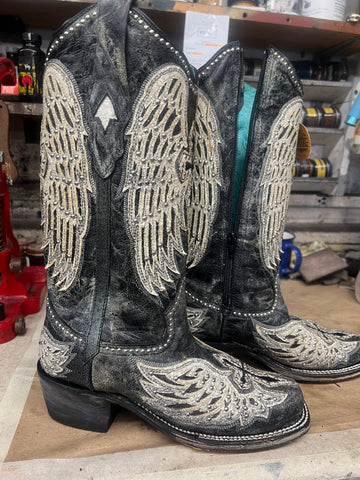 A pair of grey cowboy boots with wings