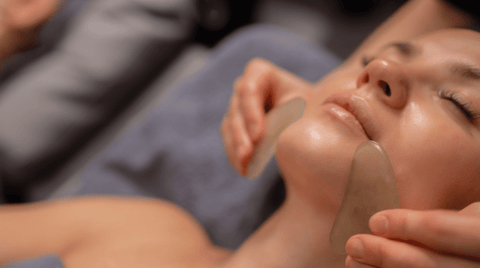 A woman receiving a gua sha treatment