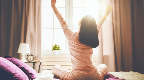 A woman stretching her arms in the morning