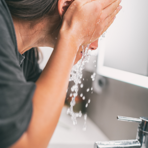 Jenny Nordic Skincare - Woman rinsing her face with water