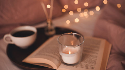 Jenny Nordic Skincare | Cozy candle light, cup of tea and an open book
