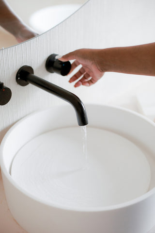 Hand turning on water tap | Jenny Nordic Skincare