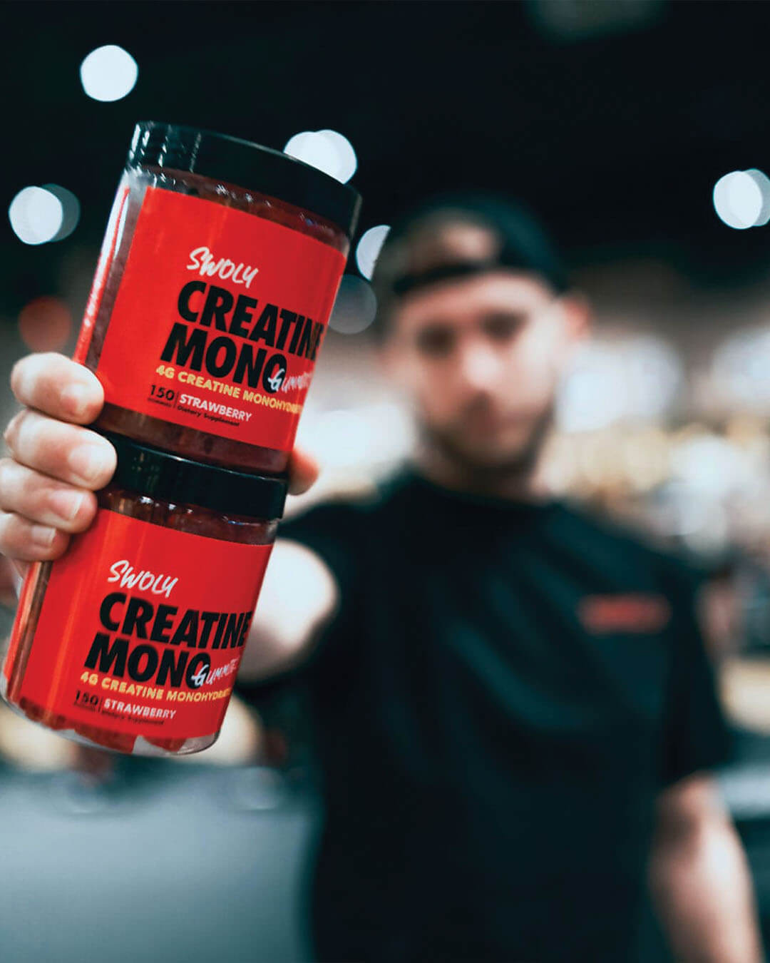 creatine monohydrate gummies container being held in fitness influencer hand, post-workout recovery, swoly