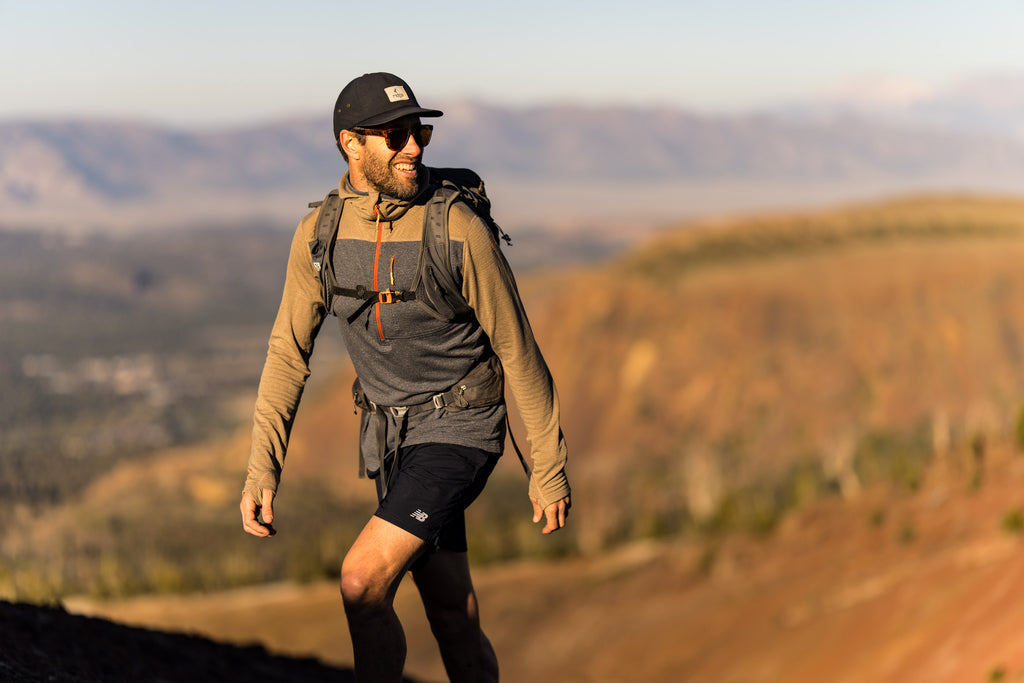 a man on a hike in Mammoth Lakes wearing a Ridge Merino hat and the Ridge Merino Convict Canyon Merino Wool Hoodie