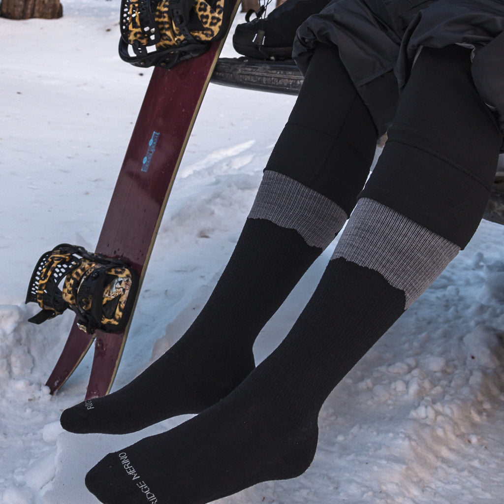 a splitboarder gets ready for a tour wearing the Ritter Merino wool sock