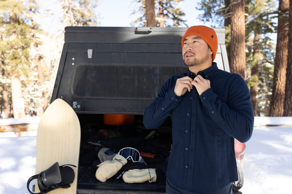a man stands by his truck getting ready for a splitboarding adventure