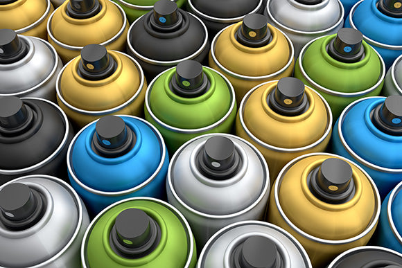 a set of multicolored aerosol cans in a row