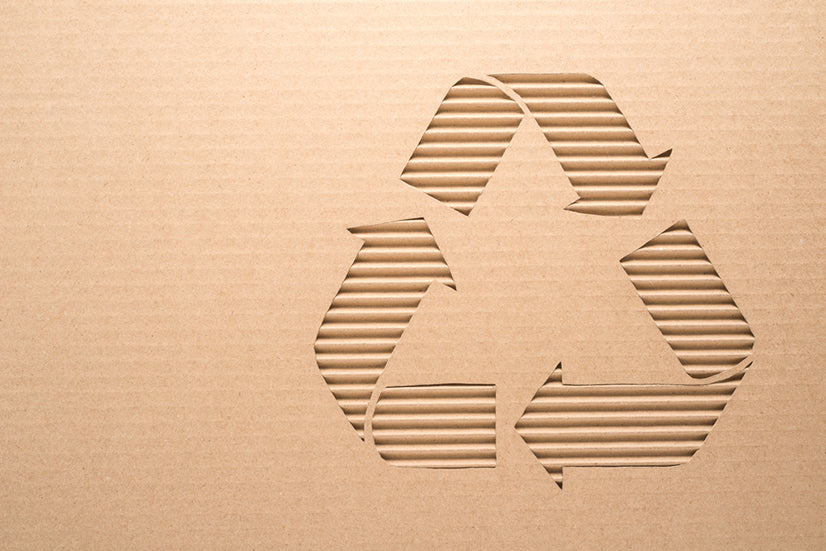 Recycle sign on a corrugated cardboard
