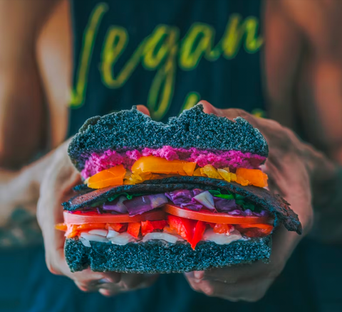 Vegan chef holding a plant based burger