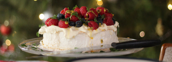 a picture of a pavlova with berries on top