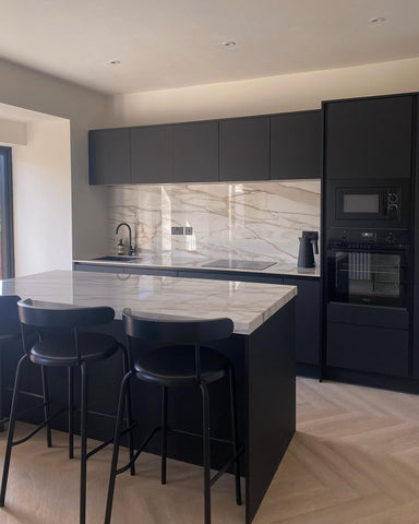 Black and white kitchen with island showcasing tap