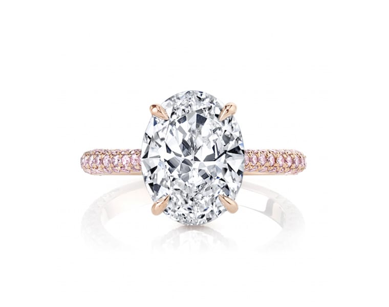 Product shot of oval engagement ring with pink diamond pavé band in rose gold