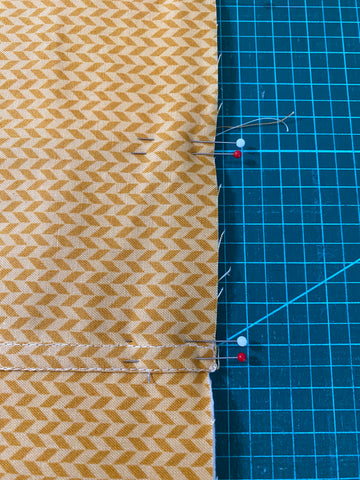 Double pinned edges of envelope pillow where seams overlap