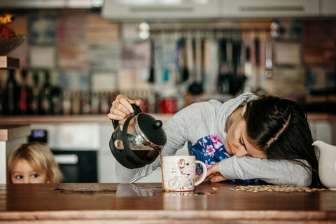 Essentially Loved Quilt exhausted mother head on table pouring coffee daughter looking on