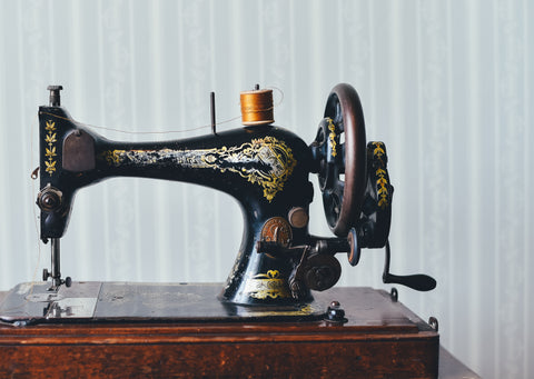 Vintage Sewing machine with gold thread partially threaded