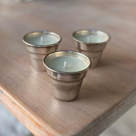 Three refilled metal candle containers