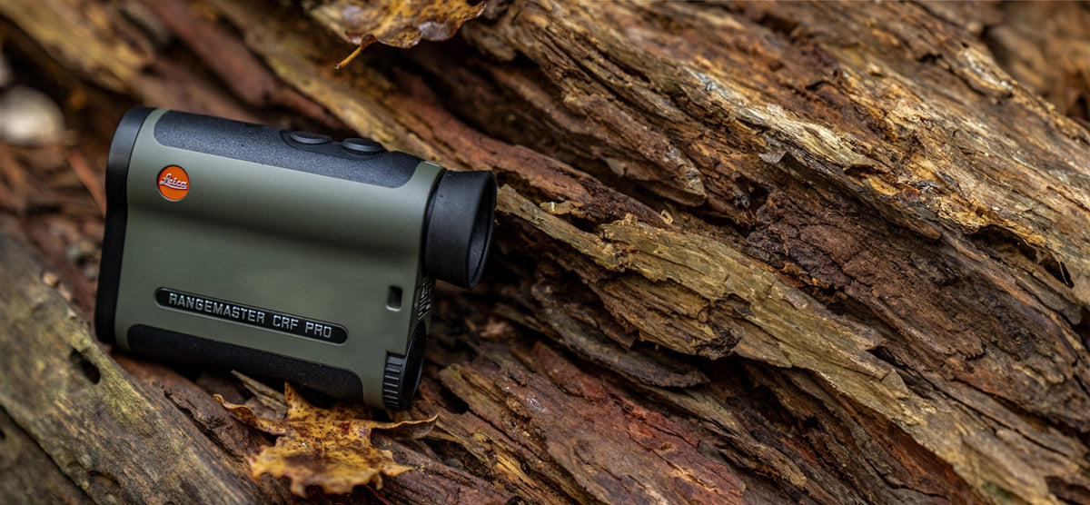 Leica Rangemaster CRF Pro desplaied on the brown tree trunk
