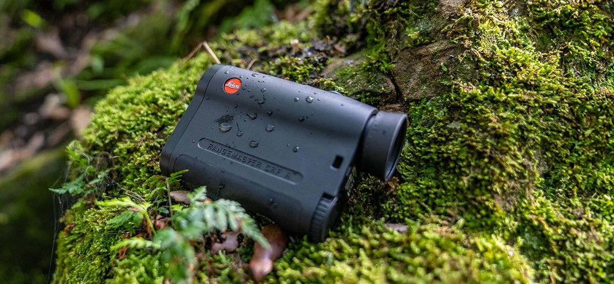 Leica Rangemaster CRF R desplaied on the stone covered with green moss