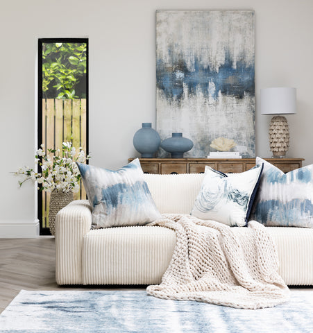 The background of your working space demonstrated to matter through the display of a curated living space featuring soft blue accessories and white upholstery. 