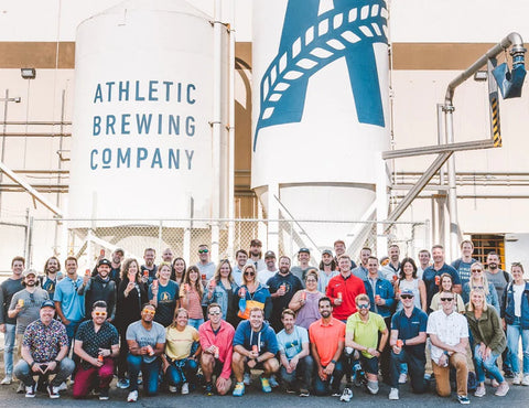 Athletic Brewing Company brewery building with a large group of people standing in front of it