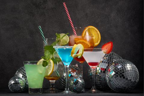 A selection of brightly colored cocktails and disco balls