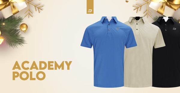 Three Academy Polo shirts in blue, beige, and black, displayed with festive decorations suggesting a holiday theme.