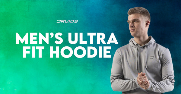 Druids Men’s Ultra Fit Hoodie modeled in light gray, featuring a form-fitting design and the brand logo, with text 'MEN’S ULTRA FIT HOODIE' in bold white letters on a vibrant teal backdrop.