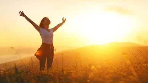 Happy-woman-in-sunset-Stress-Reduction-Techniques