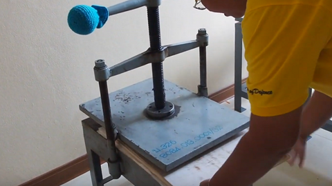 A weight is placed on top of the repaired paper(s) to smoothen the surface.
