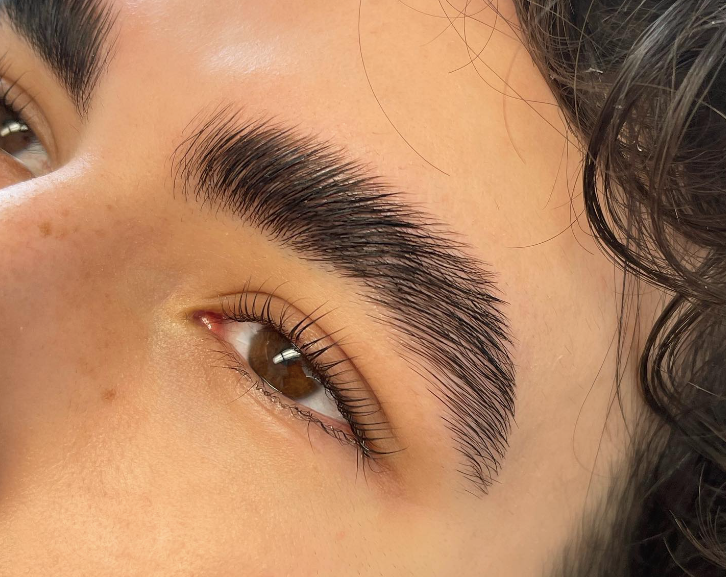 A young man with laminated lashes and brows