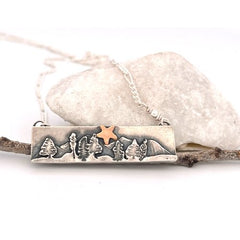 Silver bar necklace with mountains, trees, and 14k gold star