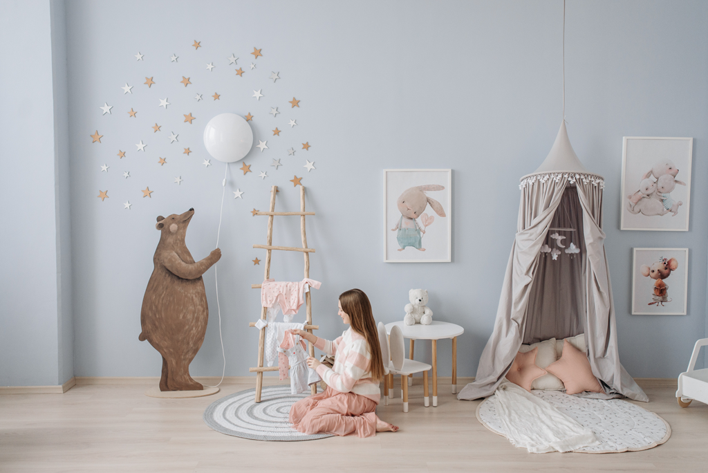 A woman in a cute baby nursery room