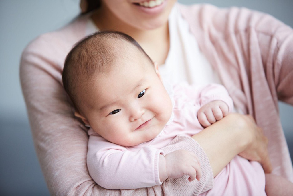 Woman holding a cute Asian baby