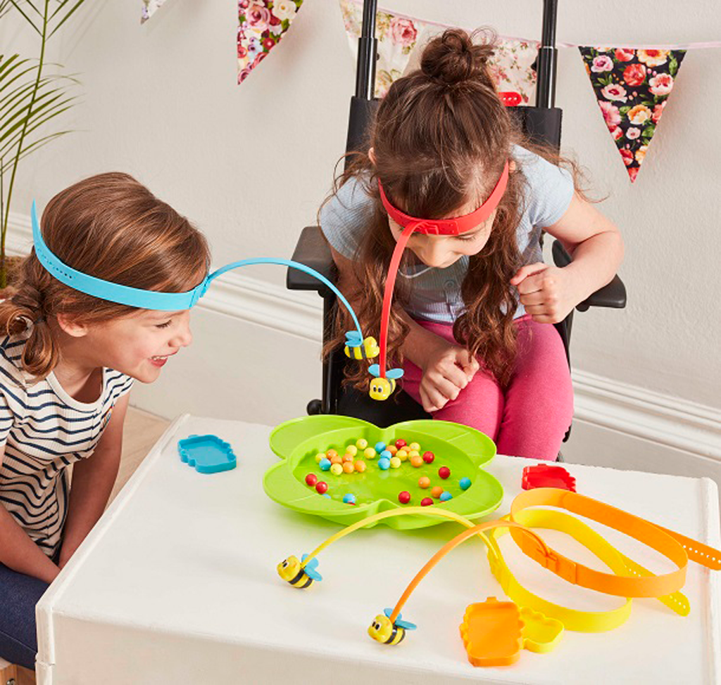 Two girls are playing colourful toys 