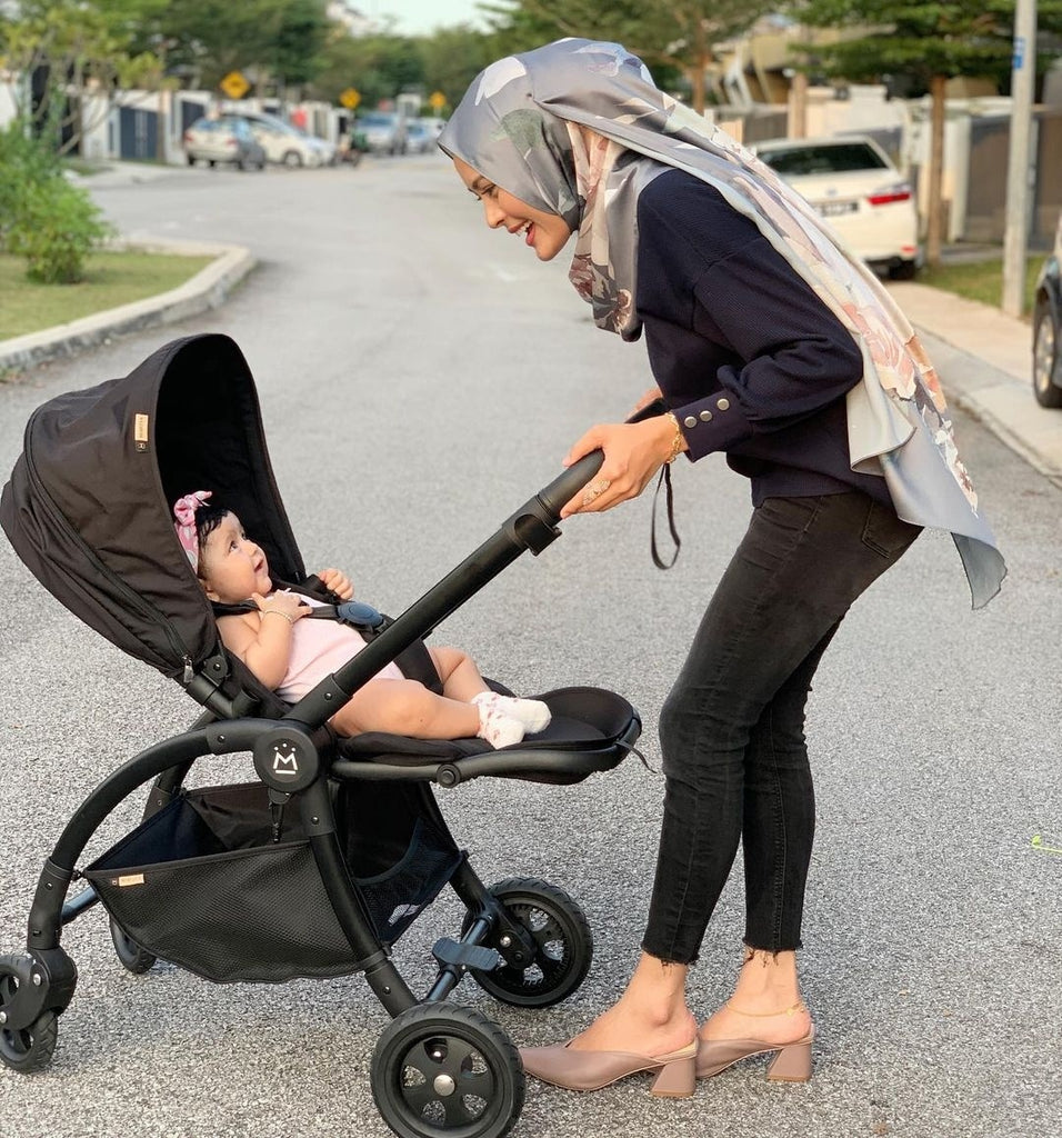 A baby girl in a mimosa stroller - to replace with a stroller that we carry in mothercare i.e. mimosa, joie, bugaboo, babyzen etc