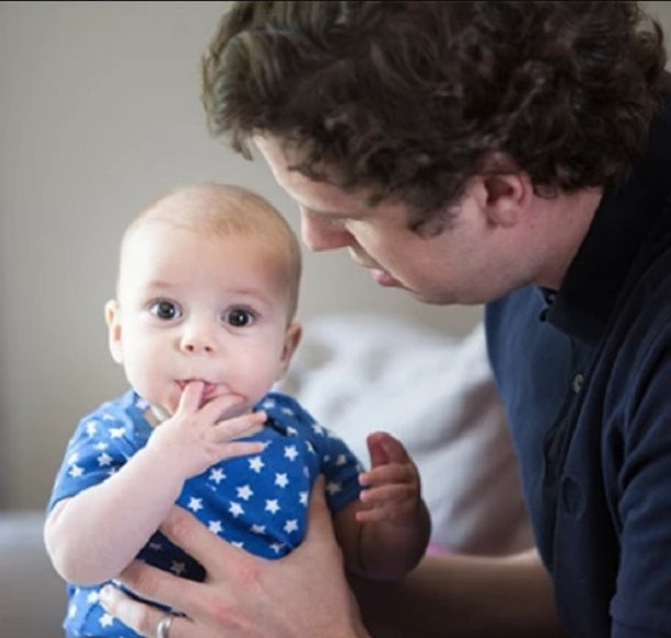 Adorable baby is biting his index finger