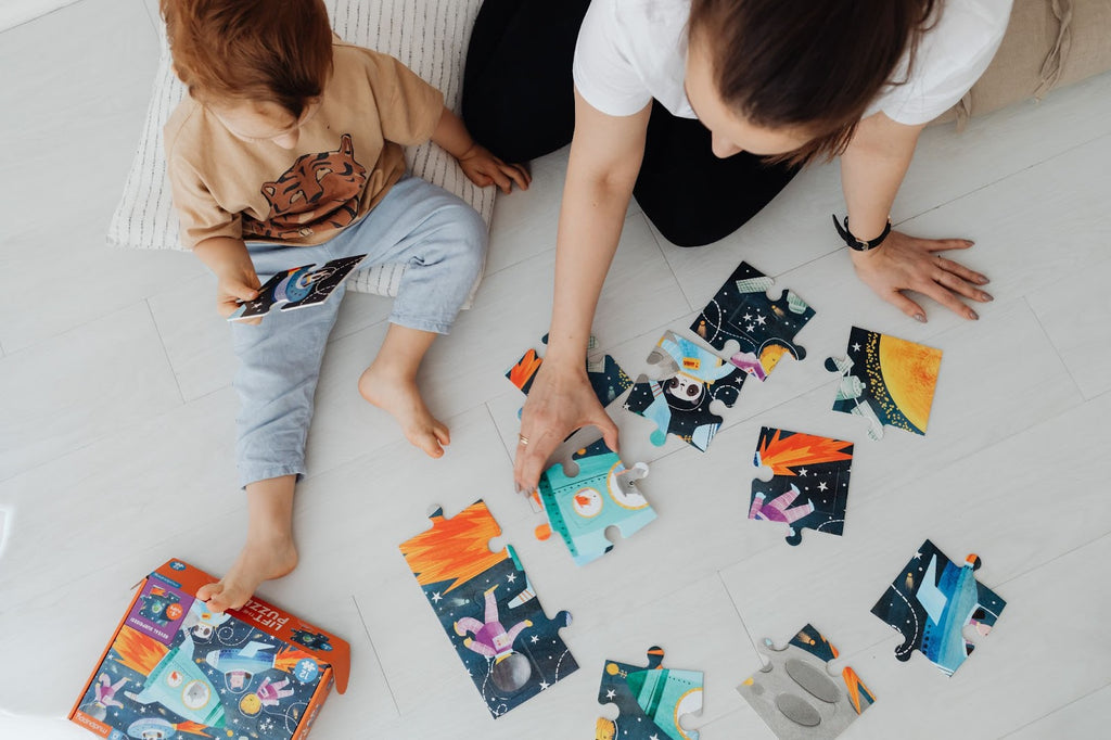 Woman and little boy playing puzzles 