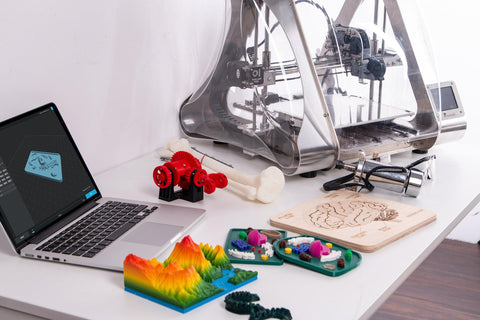 An image of a 3D printer and 3d Printed items