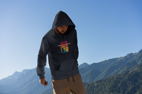 man in take a hike hoodie on mountain