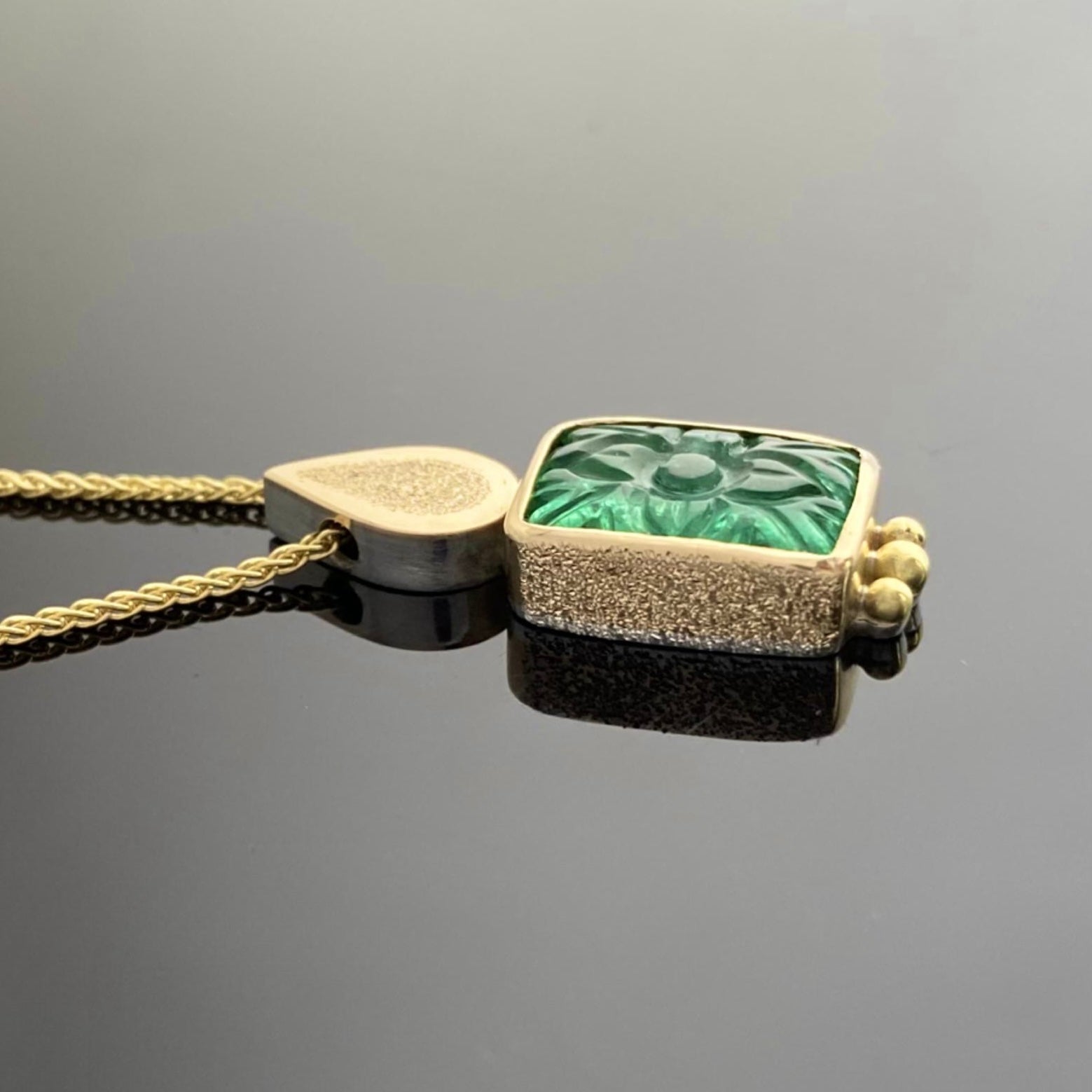 18 ct yellow gold and carved emerald pendant