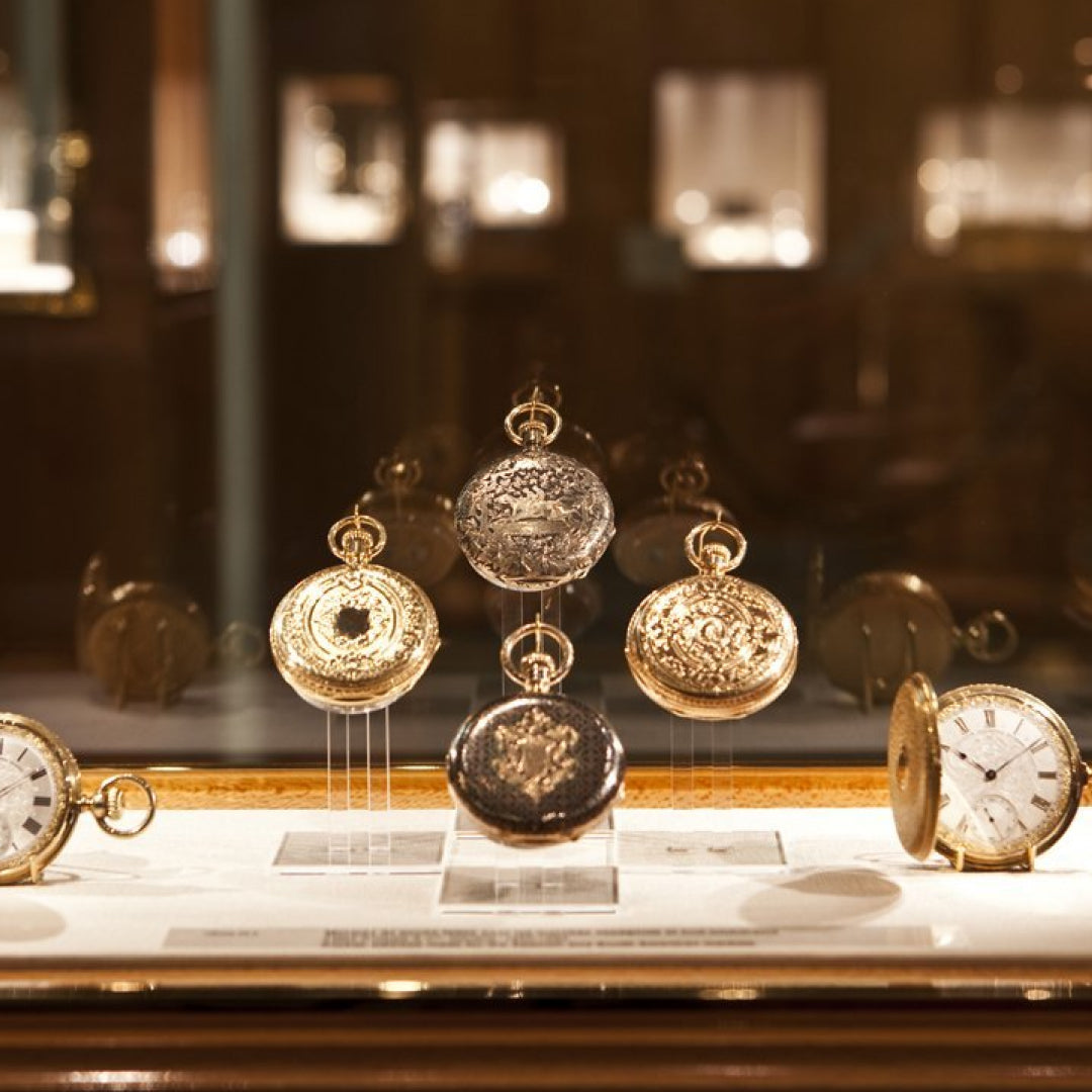 four old Patek Philippe watches inside a Museum