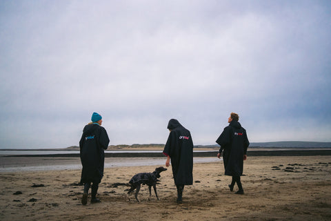 Dryrobe working the dog on the beach