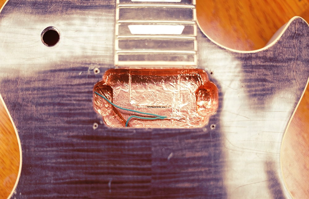 photo of the shielded neck pickup cavity with a wire attached