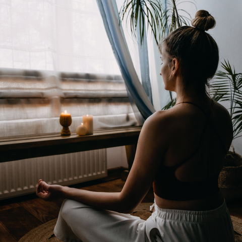 woman meditate at home looking calm relax peaceful 