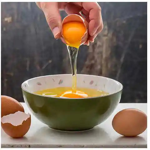 Pouring an egg into a bowl