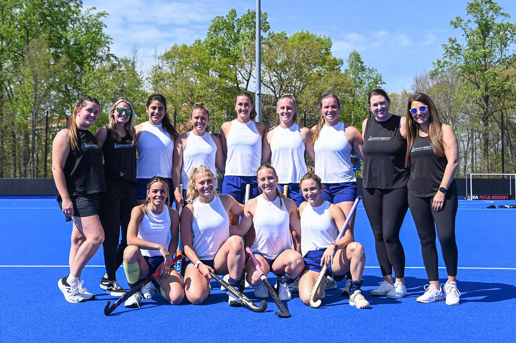 Group photo of Longstreth employees and USA Field Hockey players.